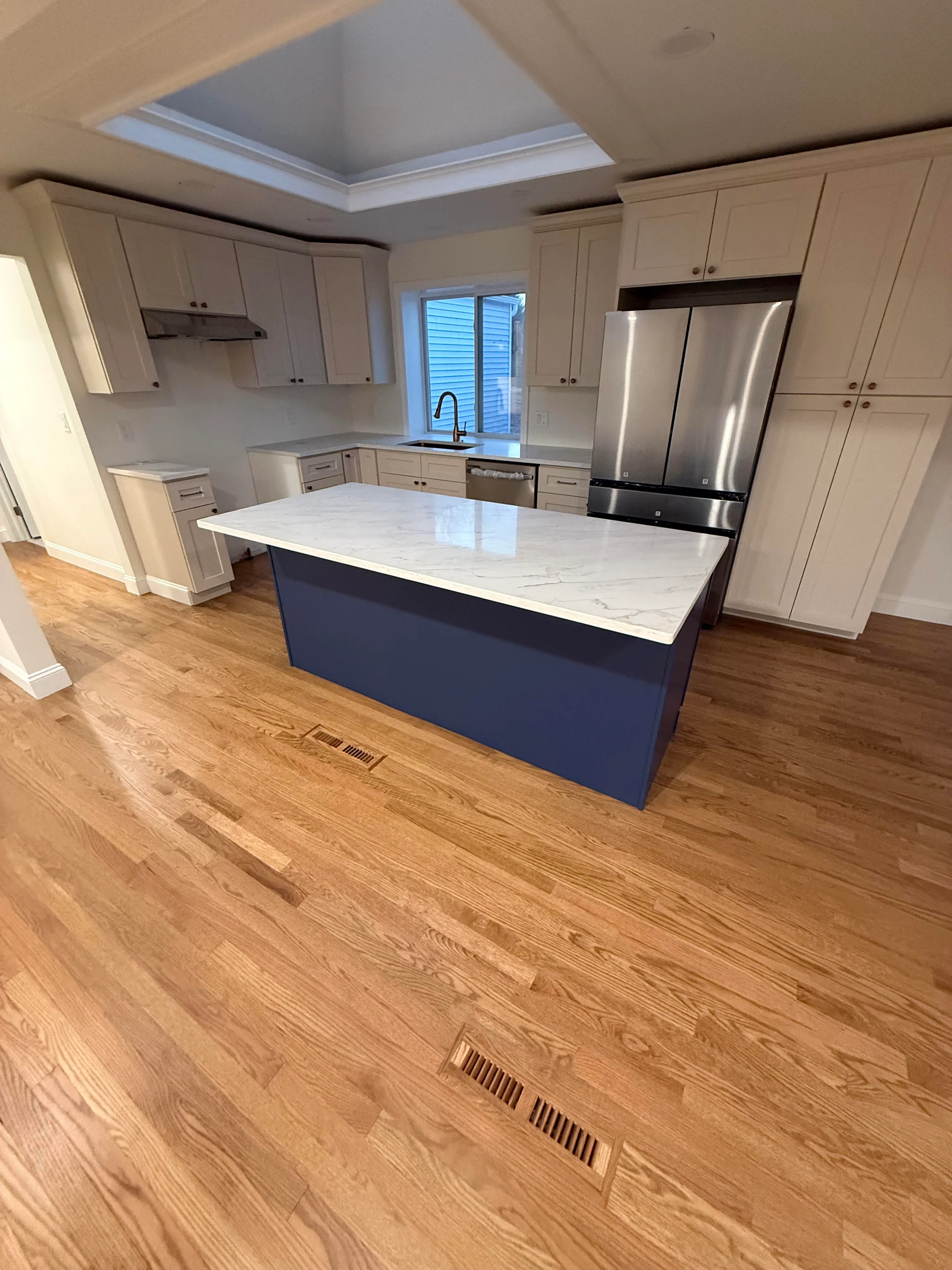 Remodeled kitchen with custom cabinetry and new countertops